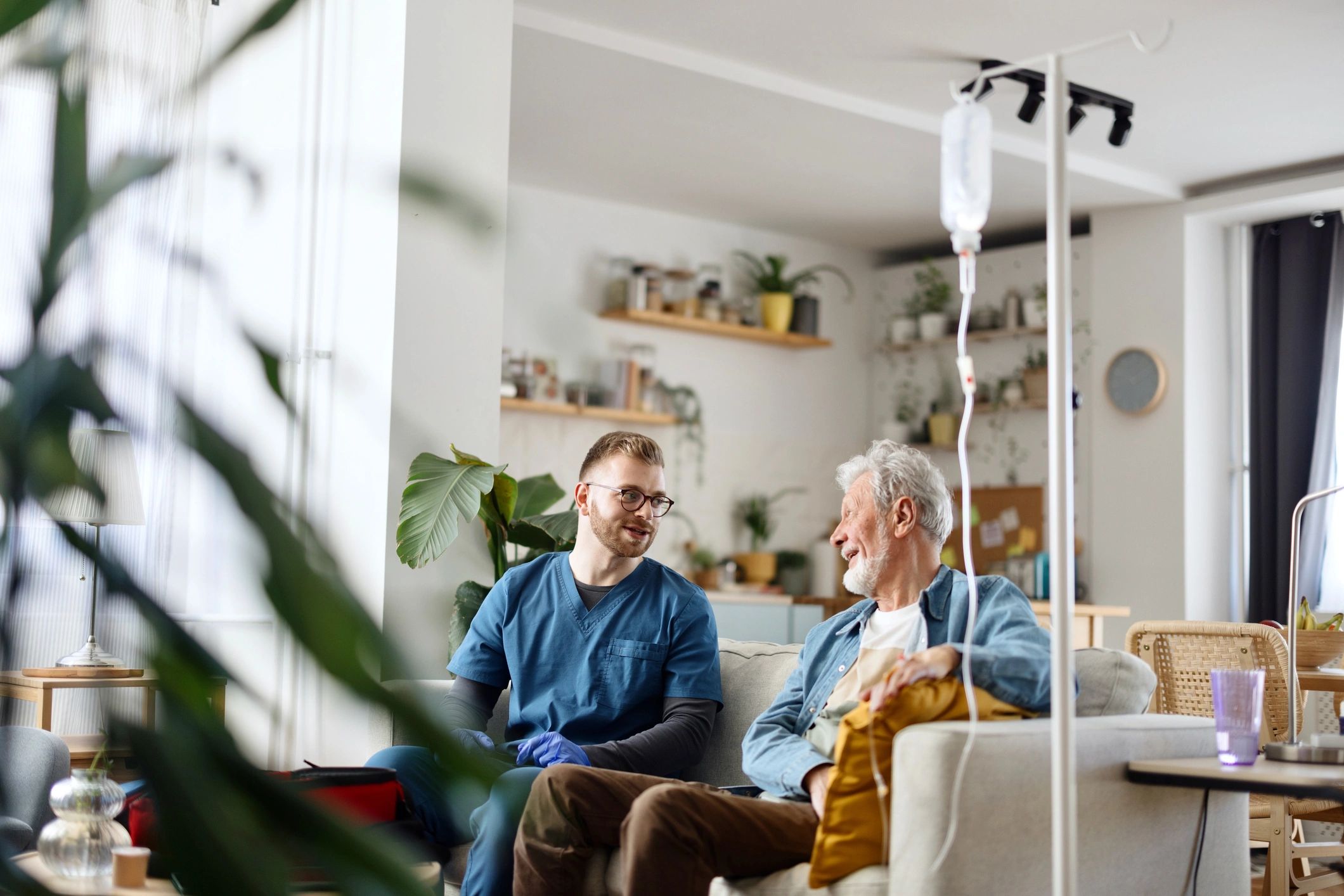 Caregiver speaking with a senior man at home