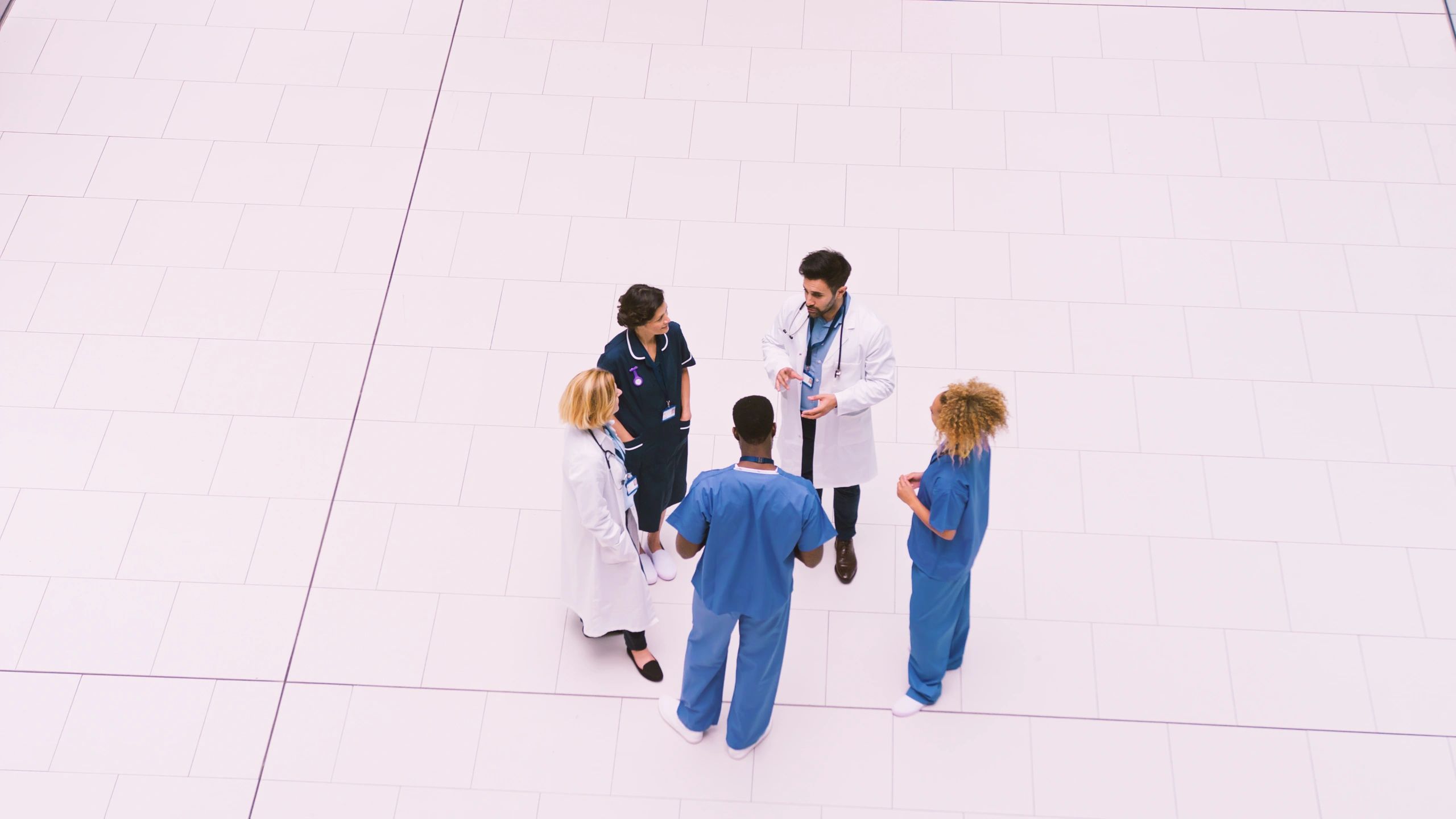 Medical staff collaborating in a modern hospital lobby